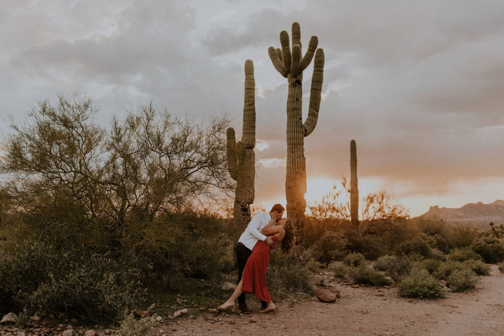 18 Top Spots For Your Destination Engagement Photos: Couple sharing a kiss during their golden hour engagement shoot  
