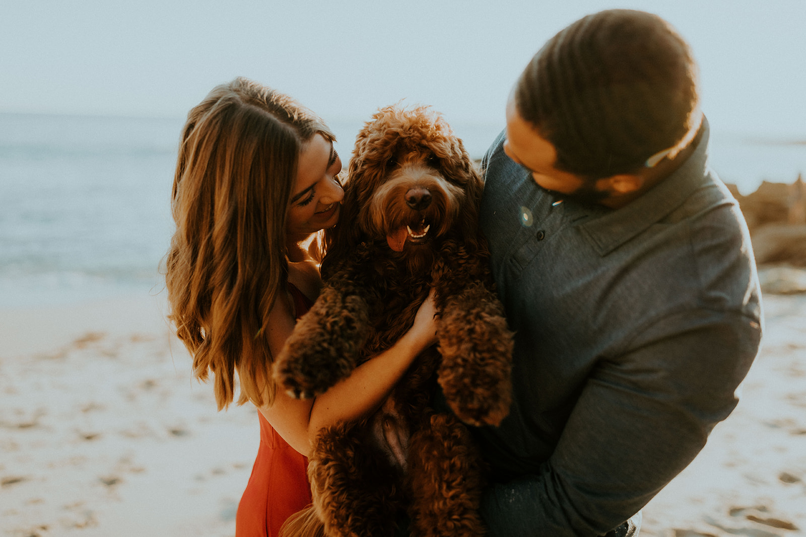 Destination Engagement Photos: Couple posing with their adorable dog at the beach, taken by McKenna Christine Photography