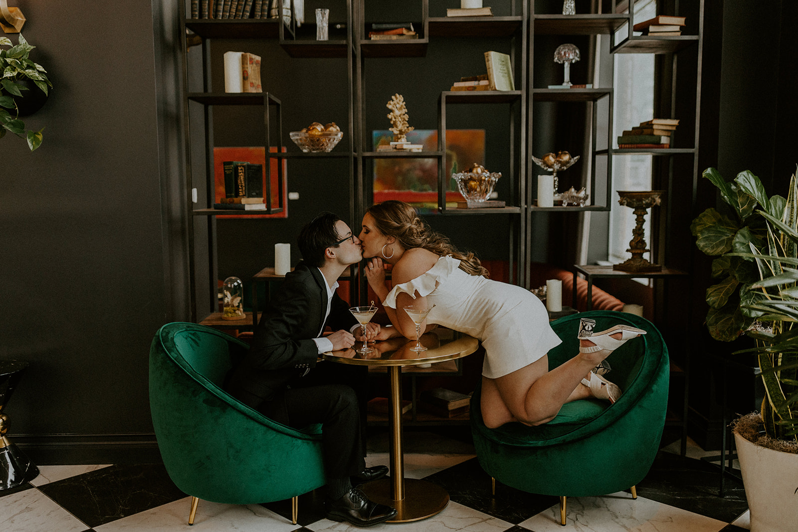 Couple sharing a kiss at a hotel boutique during their engagement session with Omaha wedding photographer McKenna Christine