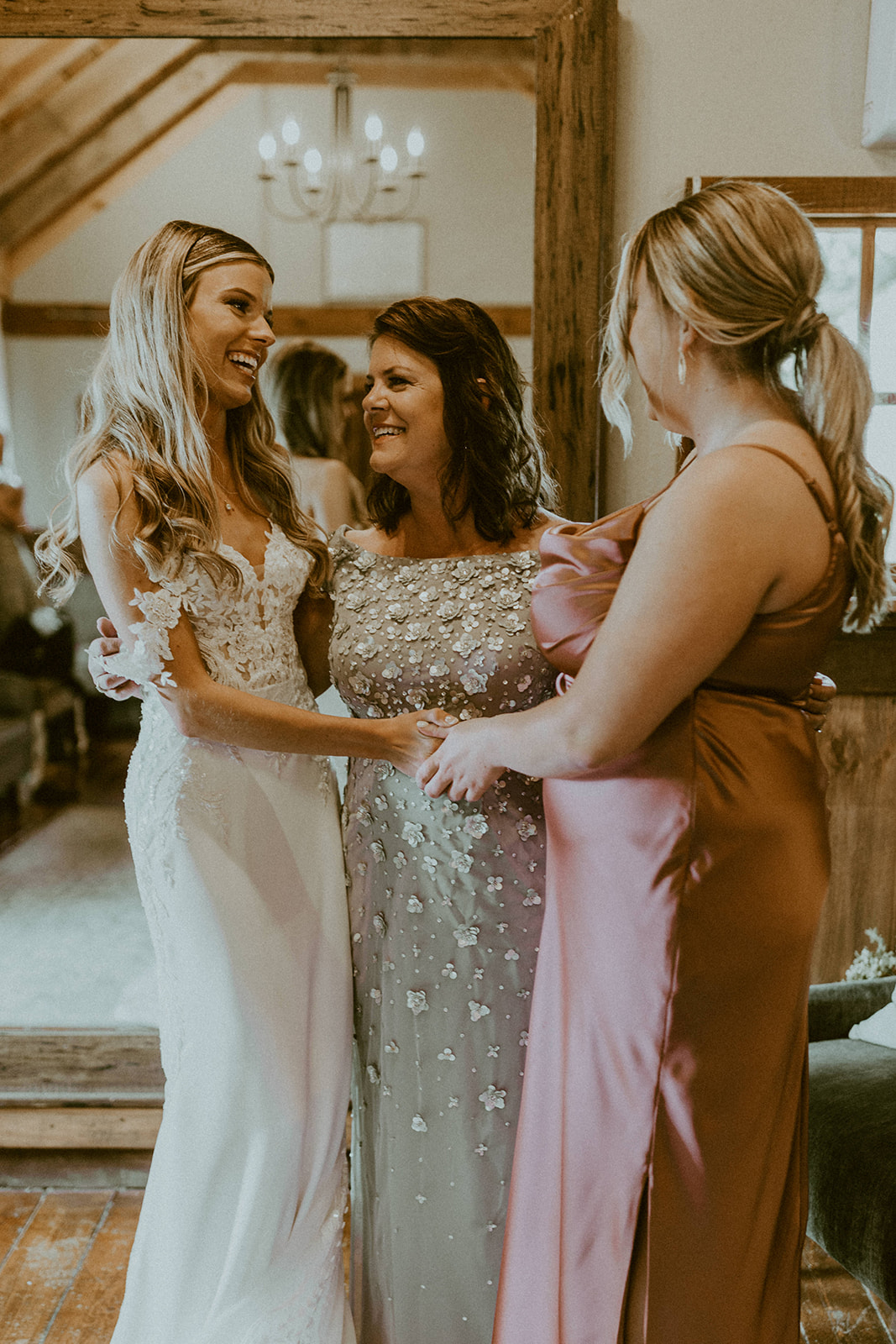 How to Choose A Wedding Photographer That's Perfect For You. Bride posing with her mother and bridesmaid.
