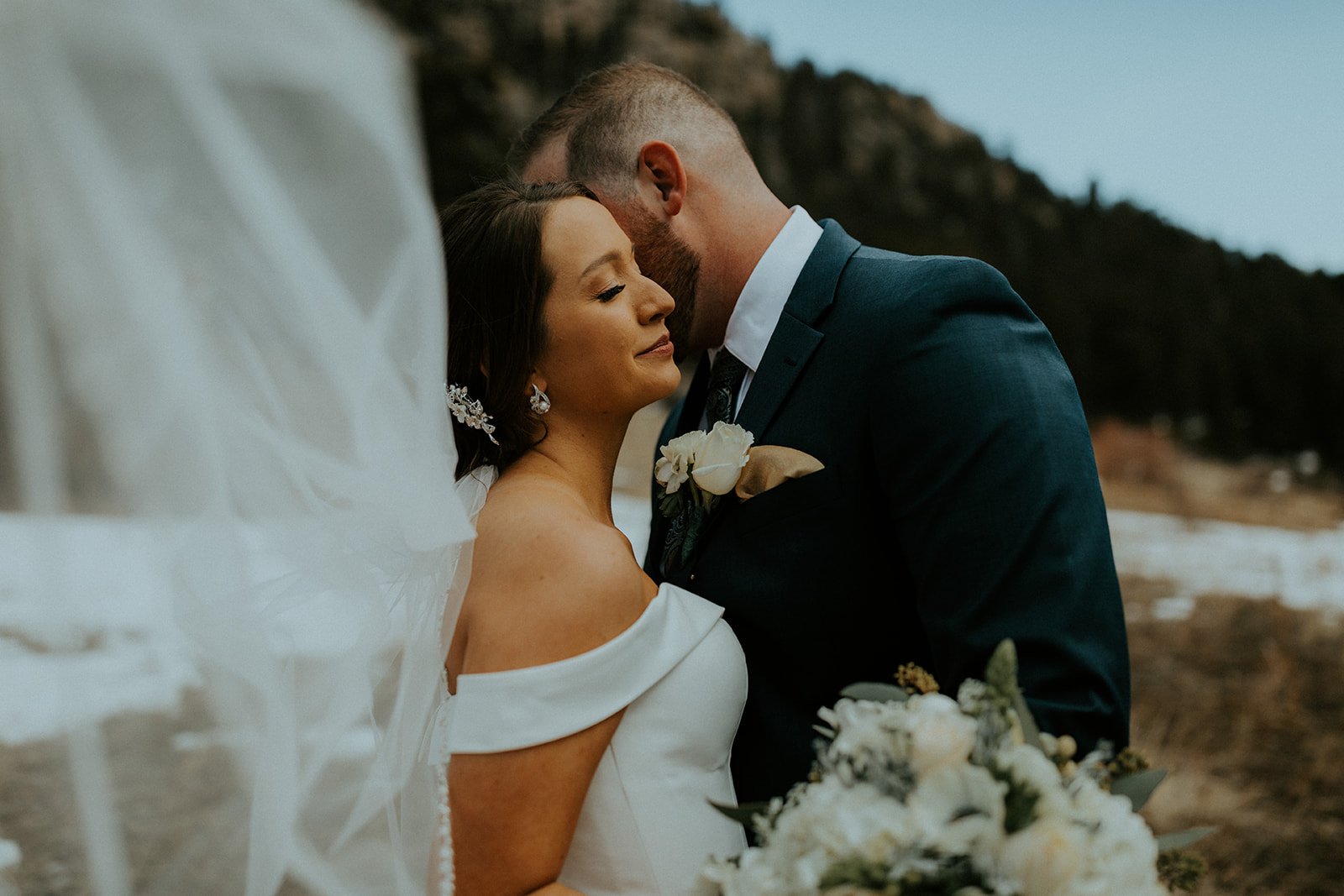 Bride and groom sharing an embrace during their Della Terra Mountain Chateau wedding shoot with McKenna Christine Photography