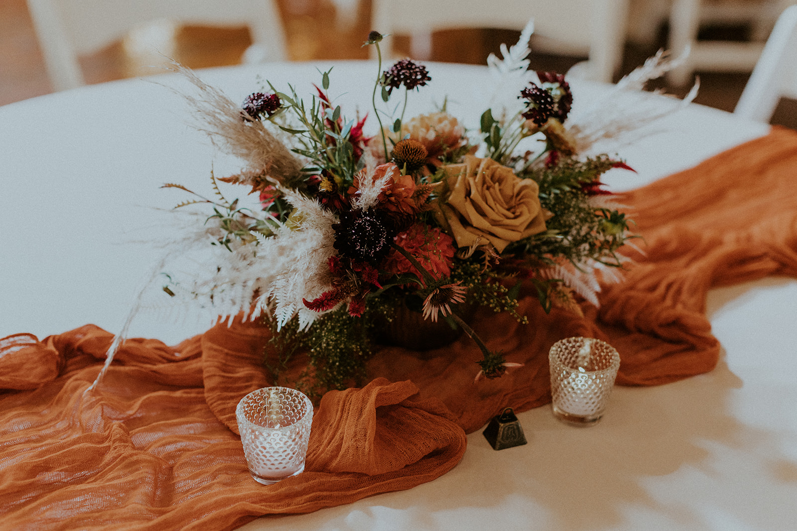 Close-up shot of wedding reception table with floral centerpiece at The Apothecary Lofts and Ridnour Room