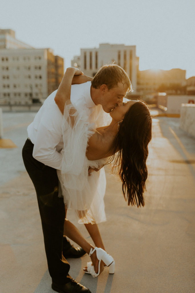 Engaged couple sharing a kiss during their photo session with McKenna Christine Photography