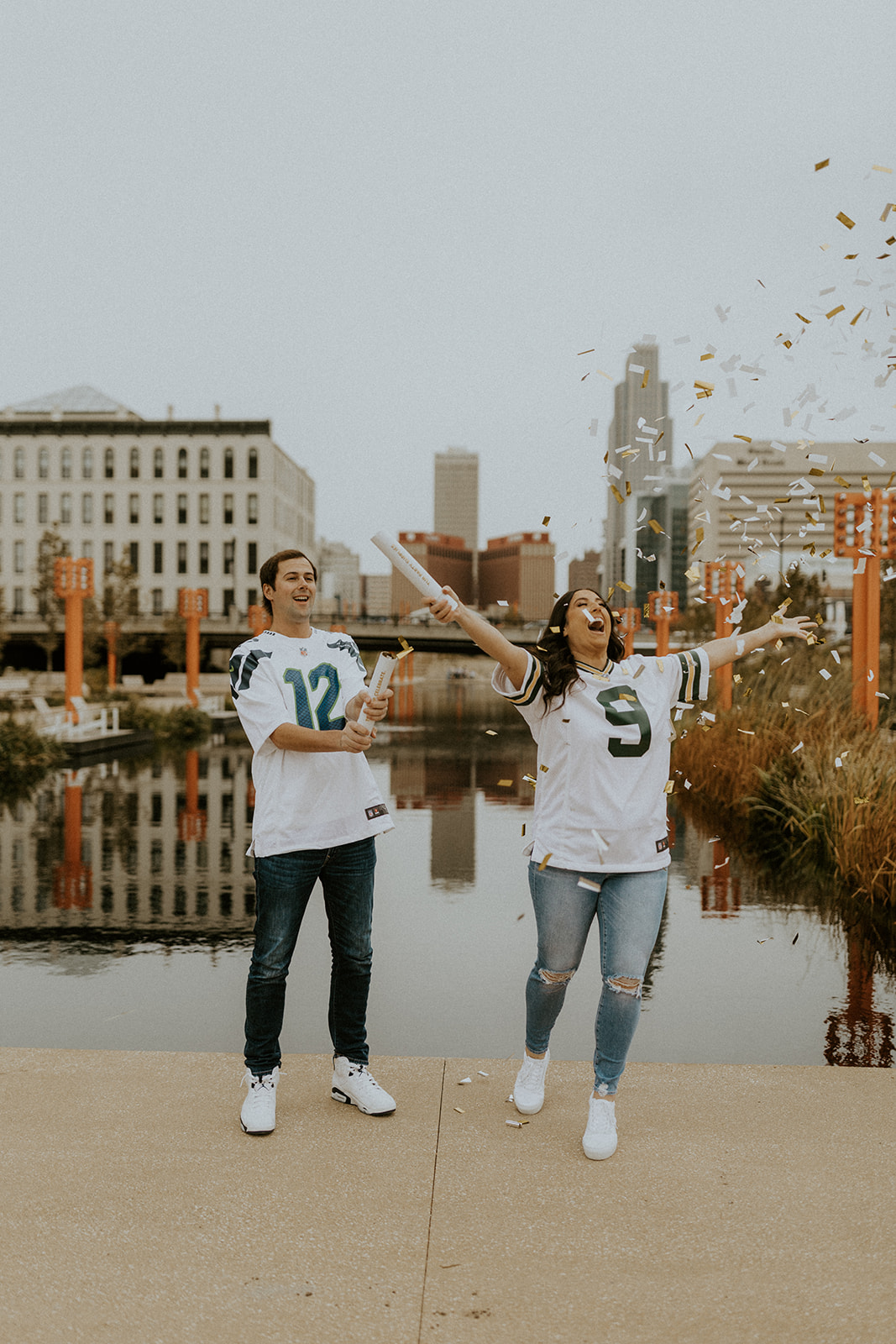 What to Wear For Engagement Photos + What NOT to Wear. Couple wearing matching jerseys as they pop confetti.