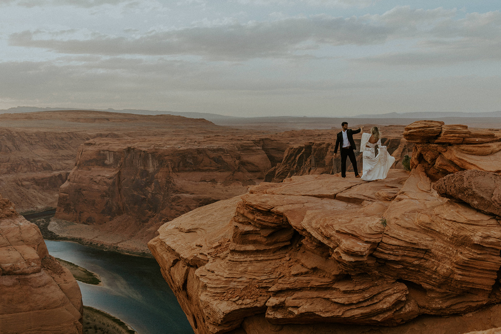 Arizona Destination Wedding: Ultimate Planning Guide. Couple posing during their Horseshoe Bend elopement.