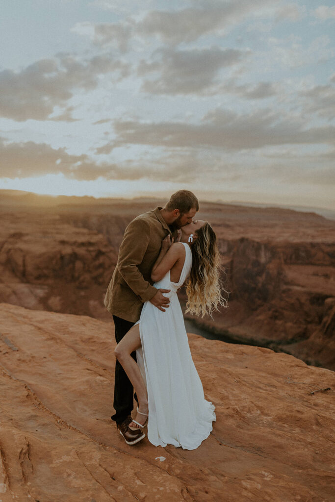 Couple sharing a kiss during their elopement shoot in Arizona during sunset