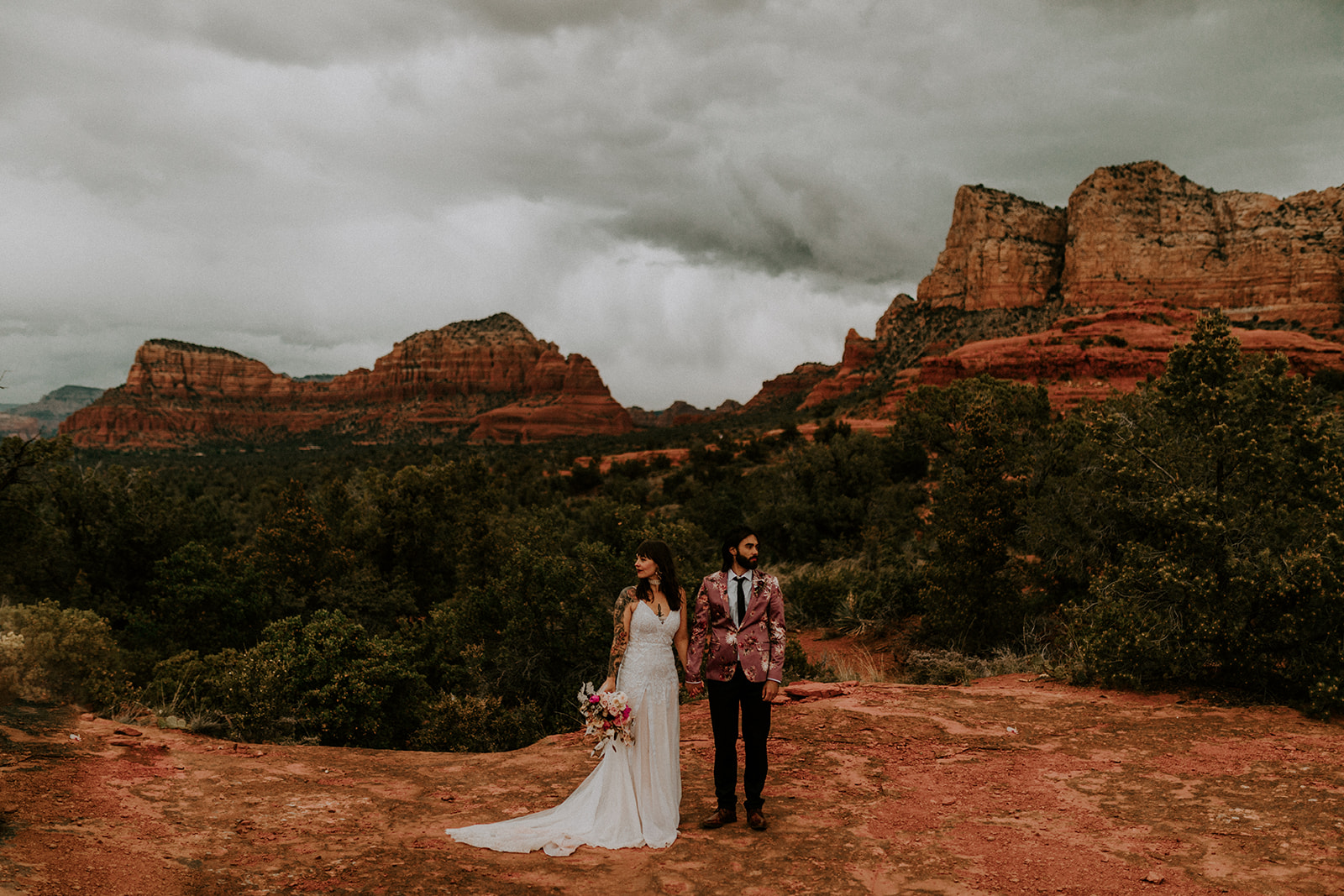 Arizona Destination Wedding: Ultimate Planning Guide. Couple holding hands and looking in different directions.