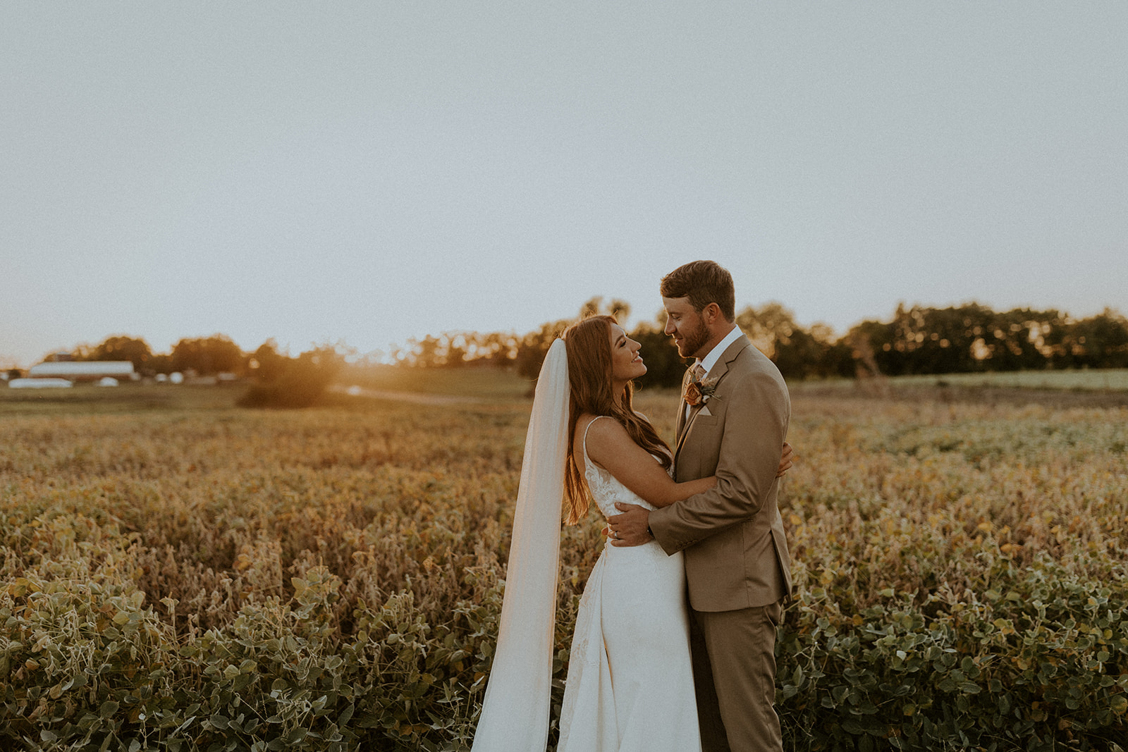 Bride and groom sharing an embrace during their autumn wedding shoot in Nebraska, captured by McKenna Christine Photography
